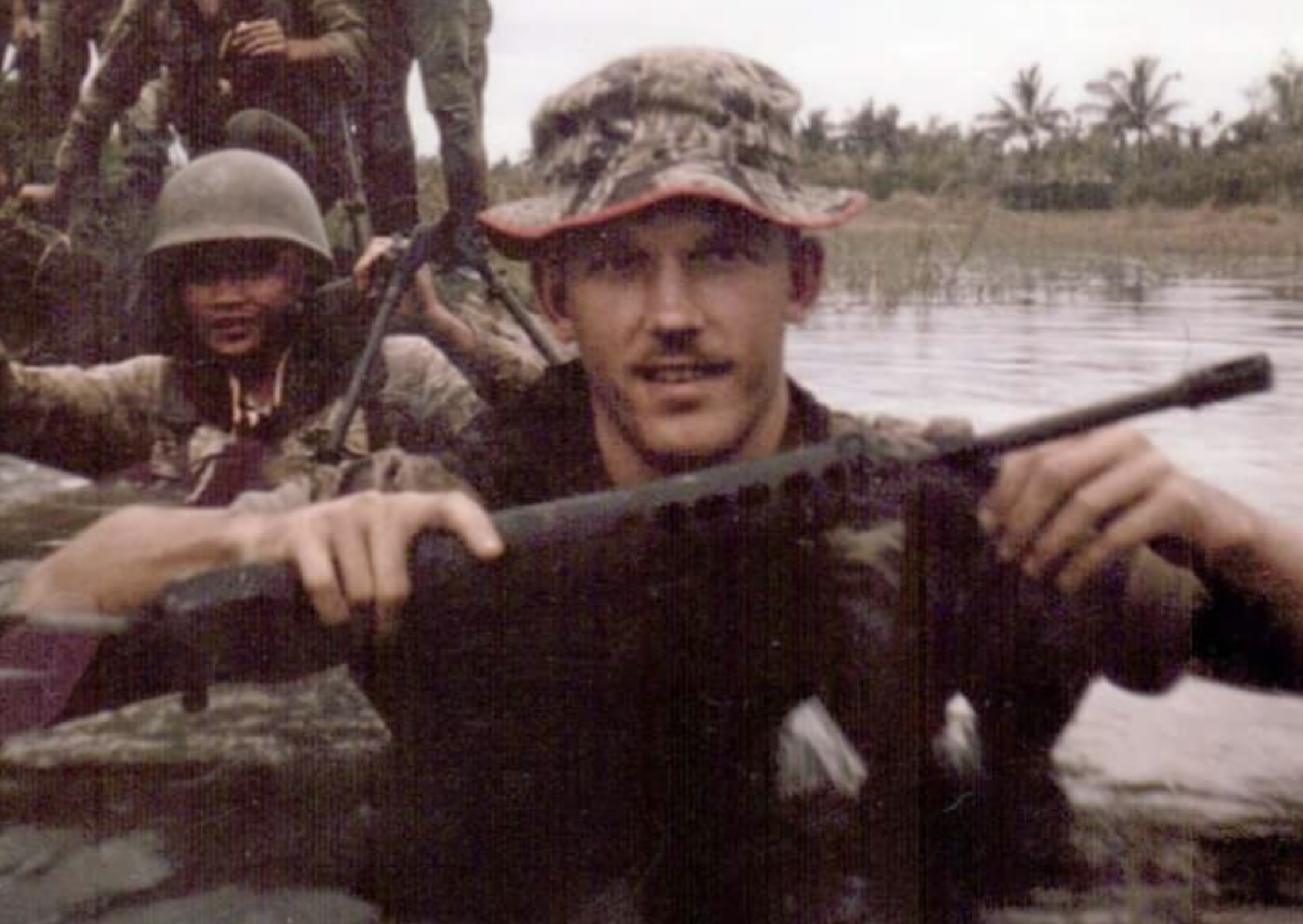 My green beret dad chest deep in water while training soldiers in Cambodia during Vietnam War, 1960s). 